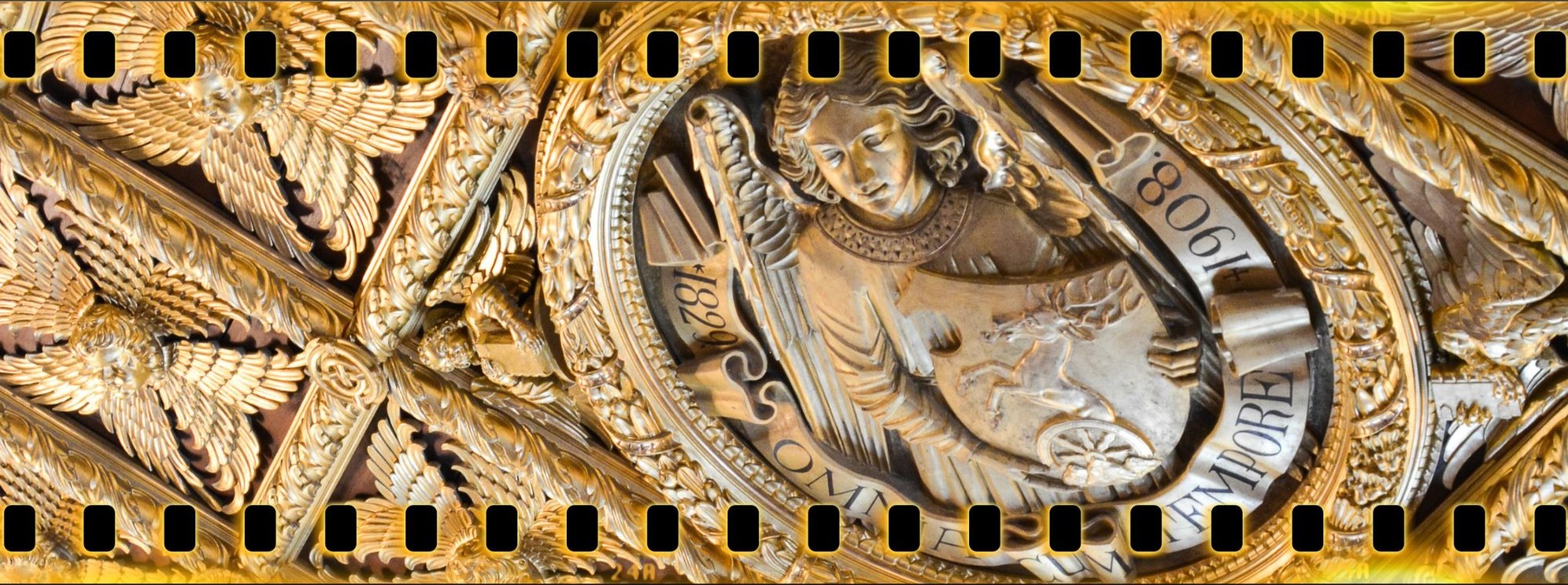 Gilded film-strip relief with eagles and a winged figure holding a shield
